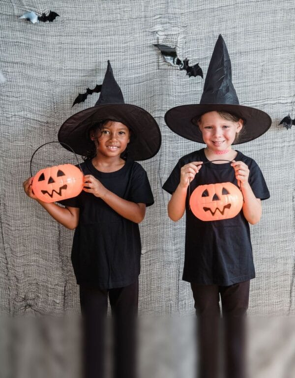 Niños disfrazados de brujos con cestas de calabaza para Halloween